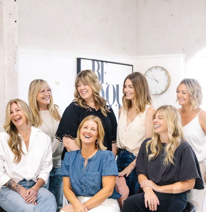 hair stylists at salt + moxie co hair salon in downtown paso robles laughing together