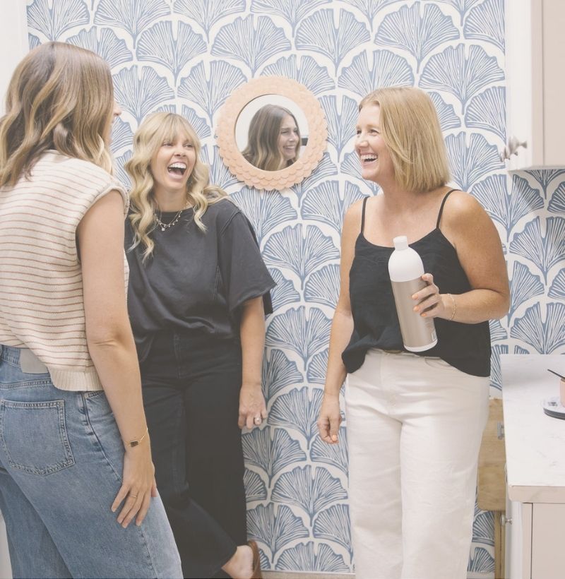 three hair stylists talking and laughing in salt + moxie hair salon in paso robles